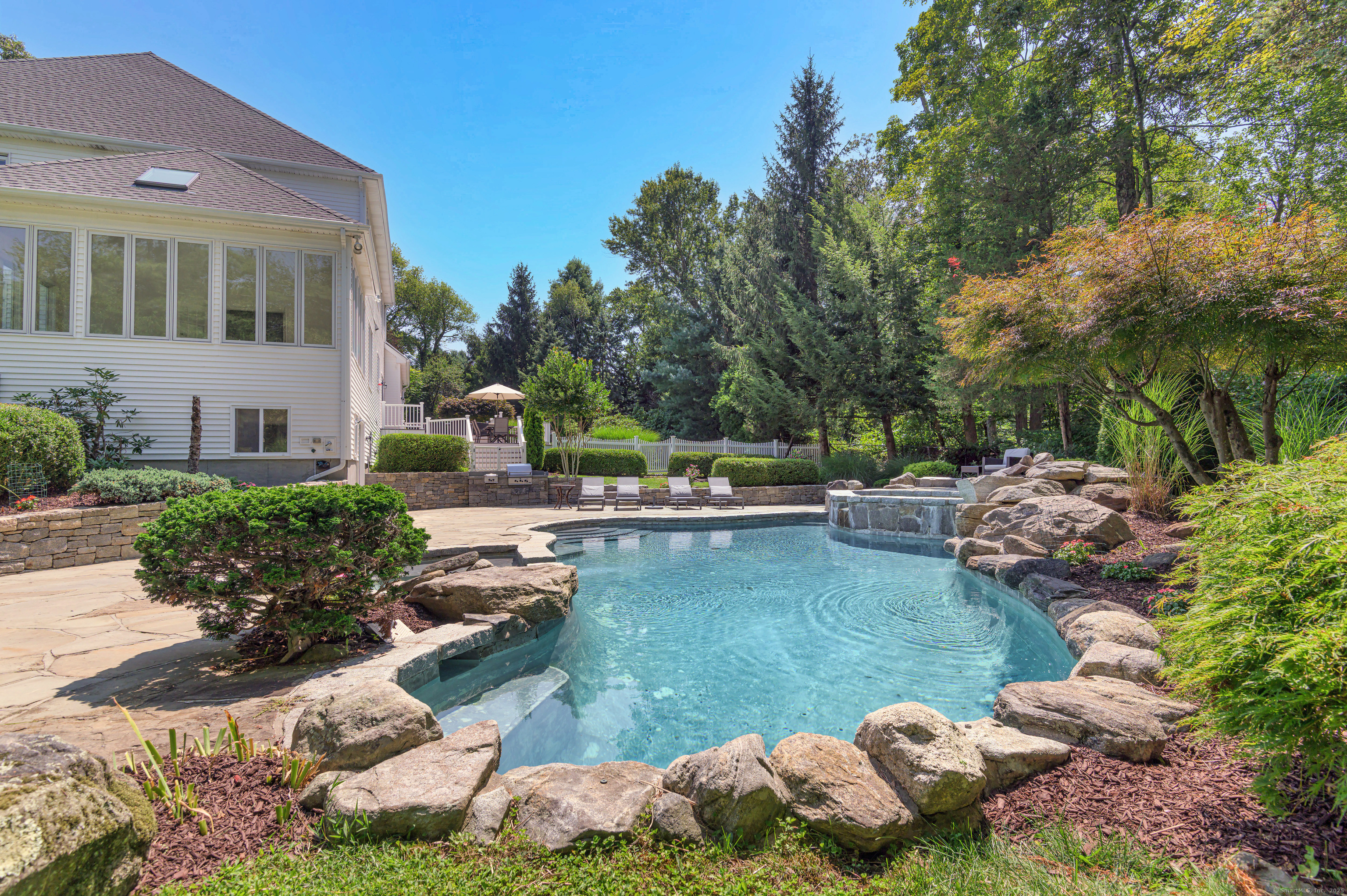 21 Schoolhouse Place Ridgefield, CT 06877 - Photo 34 of 40 a view of a swimming pool with lawn chairs and plants