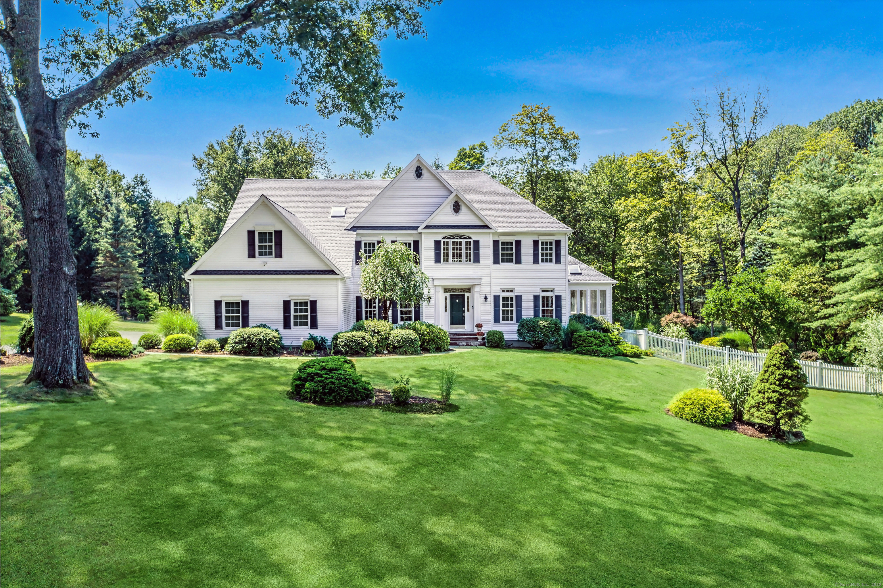 21 Schoolhouse Place Ridgefield, CT 06877 - Photo 37 of 40 a front view of a house with a yard and potted plants