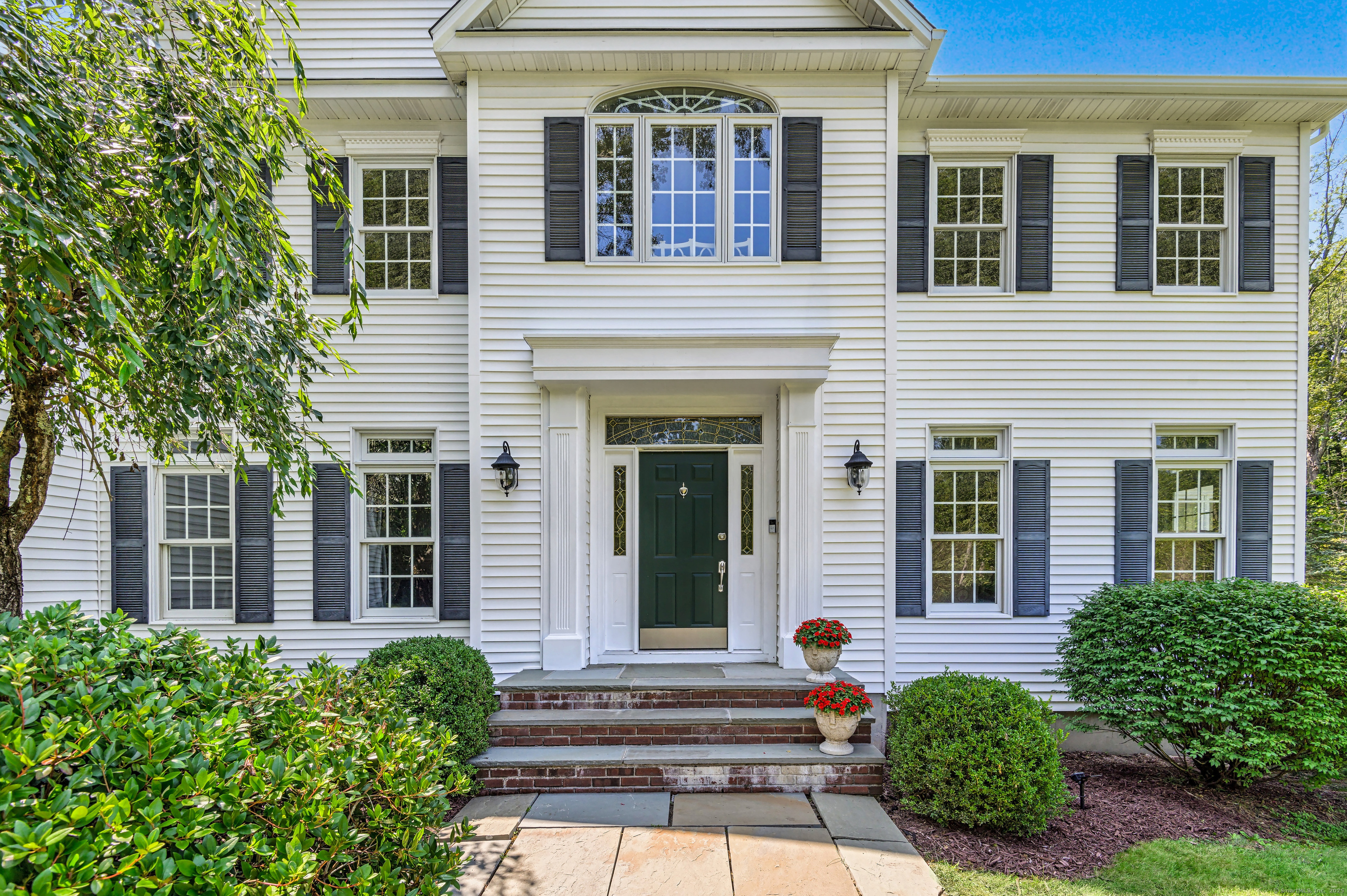 21 Schoolhouse Place Ridgefield, CT 06877 - Photo 5 of 40 front view of a house with a yard