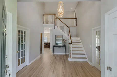 a view of entryway and hall with wooden floor
