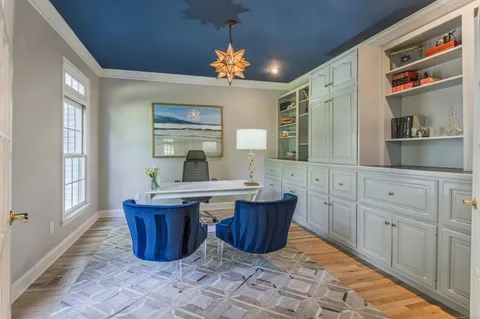 a room with furniture a chandelier a mirror and a sink