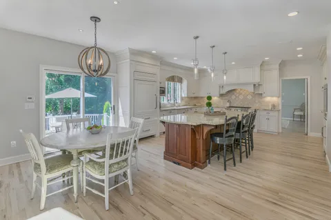 a view of a dining room with furniture wooden floor and chandelier