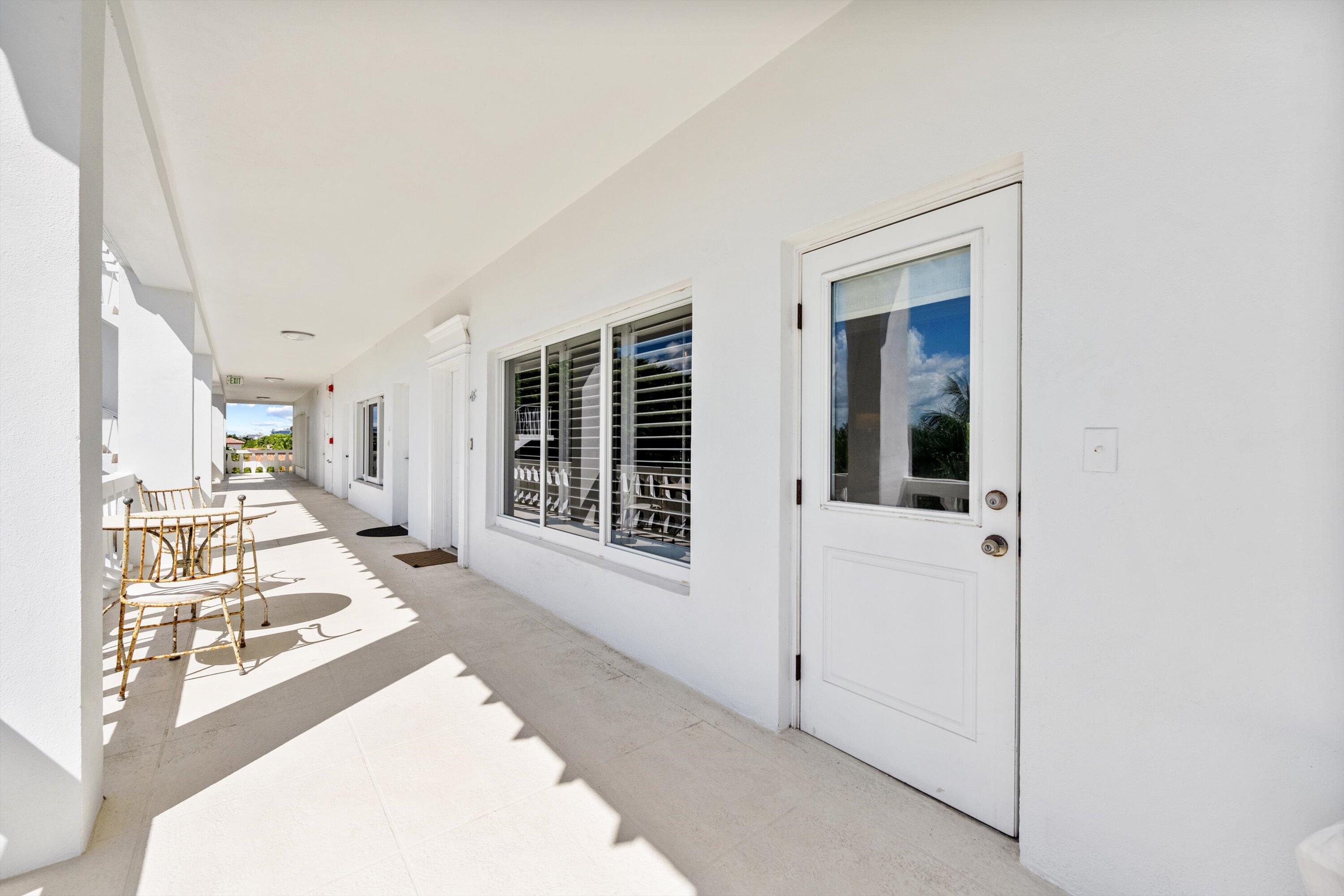 300 South Ocean Boulevard, Unit 4F Palm Beach, FL 33480 - Photo 2 of 19 a view of a hallway with wooden floor and windows