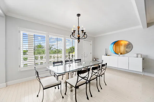 a dining room with chandelier a wooden table and chairs
