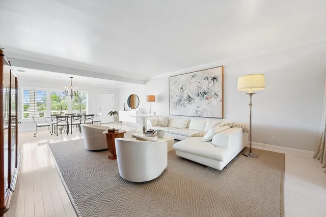 a living room with furniture a window and a table