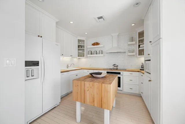 a kitchen with cabinets appliances a sink and a counter top space