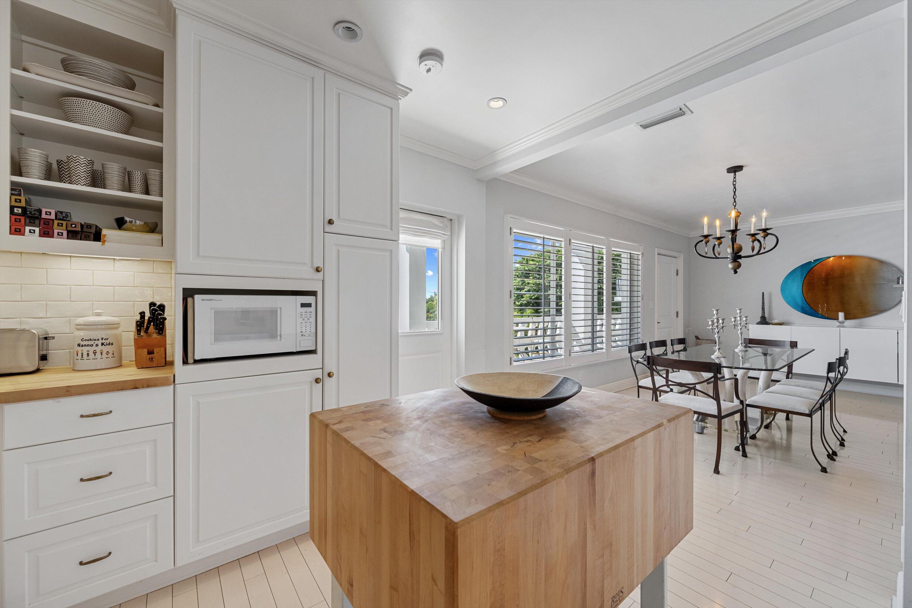 300 South Ocean Boulevard, Unit 4F Palm Beach, FL 33480 - Photo 9 of 19 a kitchen with stainless steel appliances kitchen island granite countertop a sink a stove and a wooden floors