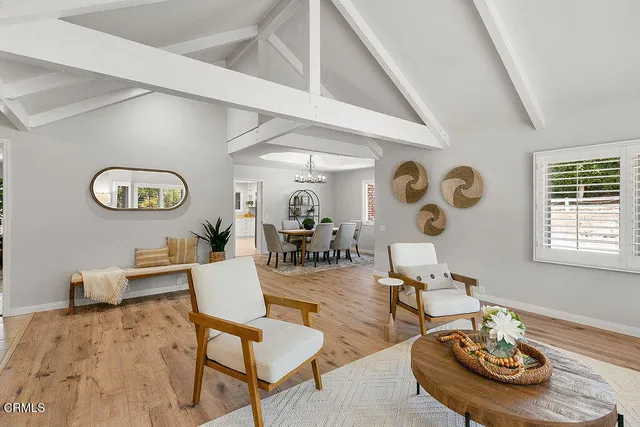 a view of a dining room with furniture and chandelier