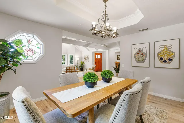a kitchen with white cabinets a window and appliances