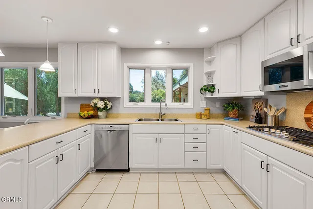 a utility room with cabinets washer and dryer