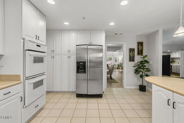 a bedroom with a bed and a potted plant