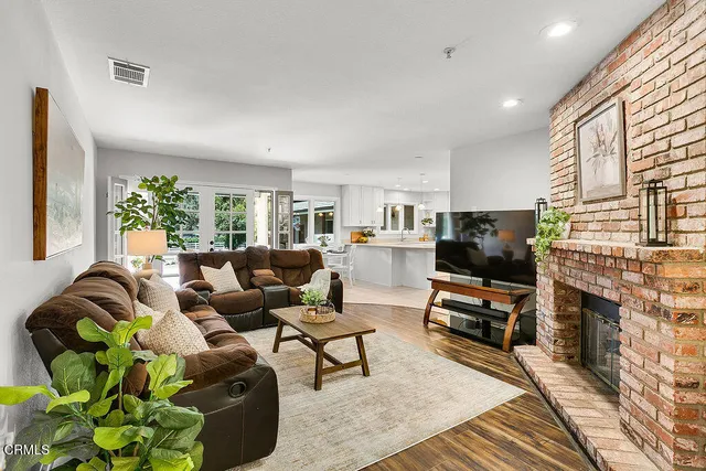 a bathroom with a sink a mirror and a potted plant