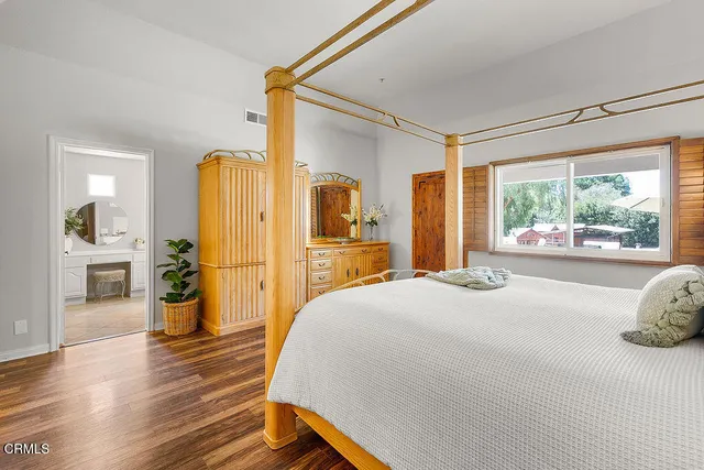 a bed room with a bed and a potted plant