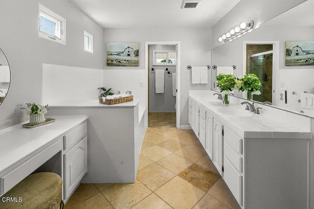 a room with furniture a flat screen tv and a window