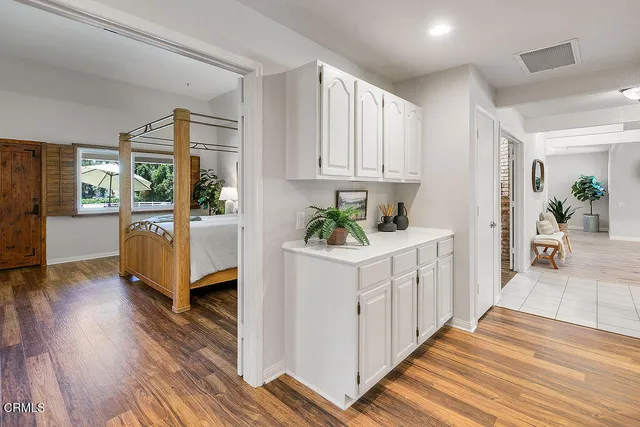 a front view of a house with cars parked
