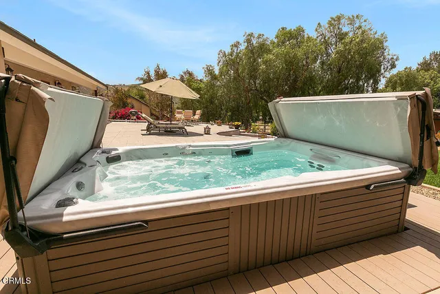 a backyard of a house with barbeque oven table and chairs