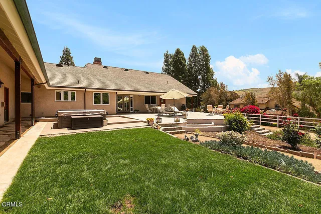 an aerial view of a house with a yard and outdoor seating