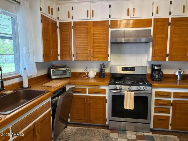 a kitchen with a stove and a sink