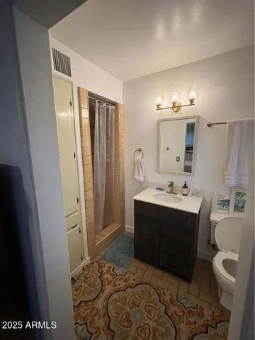 a bathroom with a sink vanity and mirror