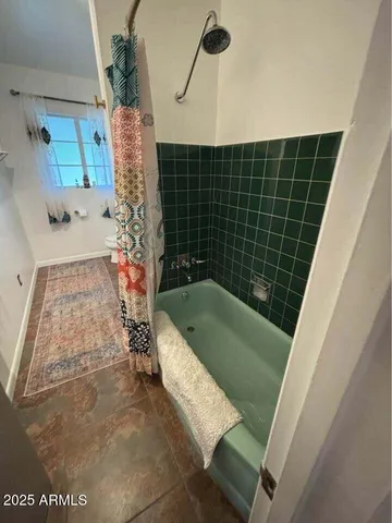 a bathroom with a tub and shower