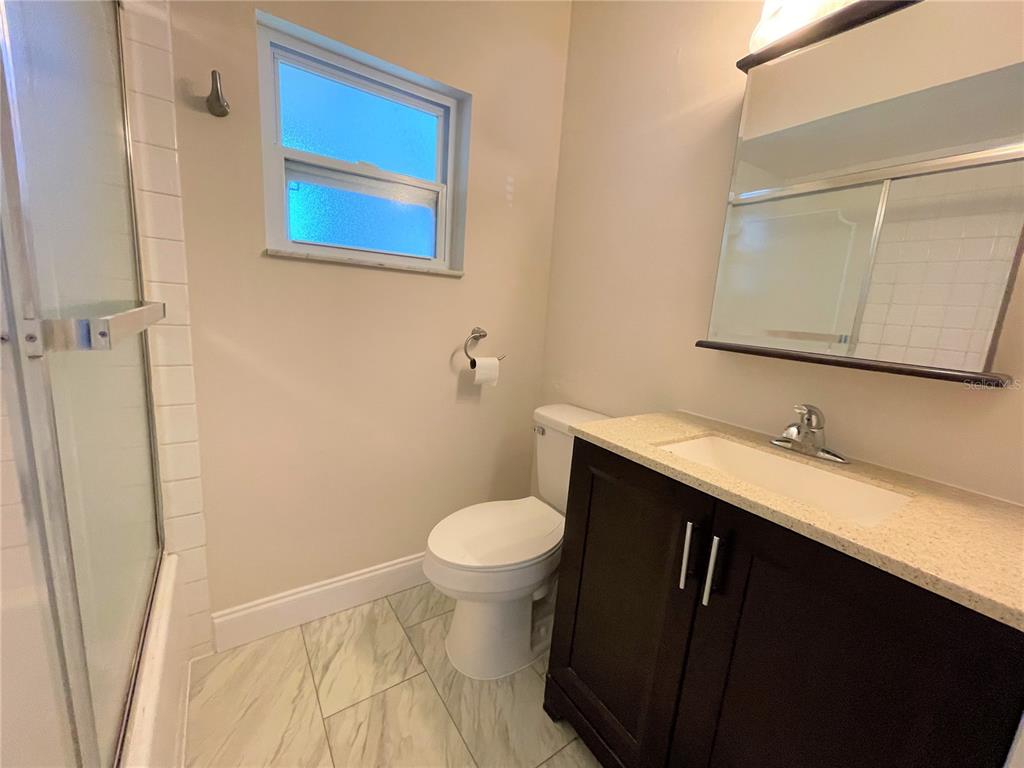 9 Jeff Road Largo, FL 33774 - Photo 15 of 23 a bathroom with a sink and a toilet