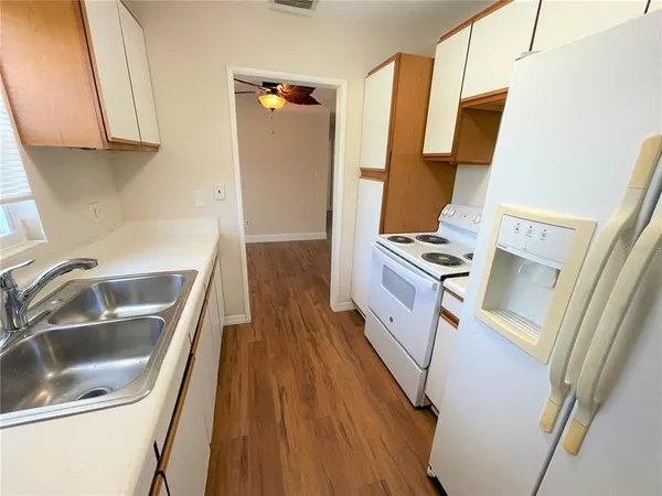 a kitchen with sink and refrigerator