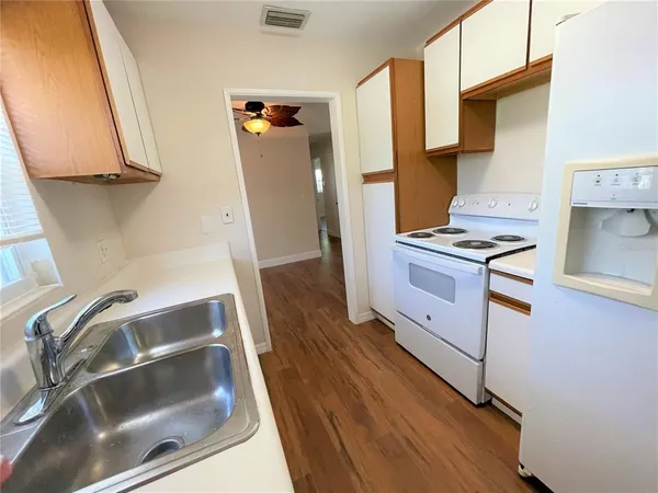 a kitchen with stainless steel appliances granite countertop a refrigerator and a stove