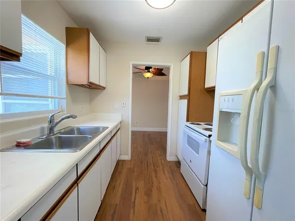 a kitchen with a sink and refrigerator