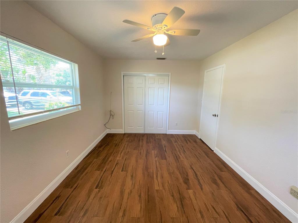 9 Jeff Road Largo, FL 33774 - Photo 22 of 23 wooden floor in an empty room with a window