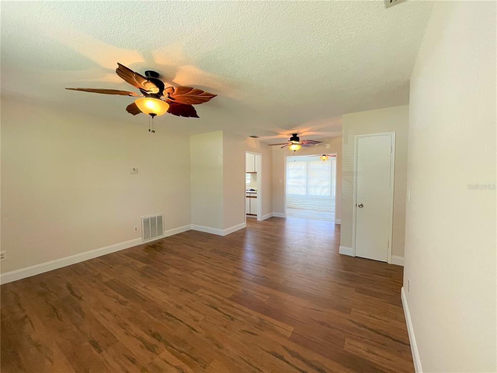 9 Jeff Road Largo, FL 33774 - Photo 8 of 23 wooden floor in an empty room