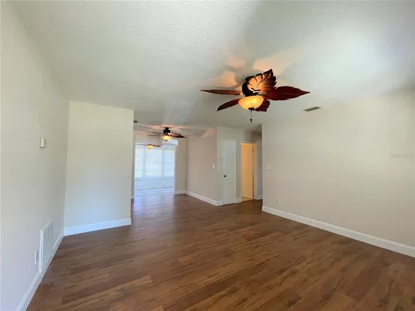 a view of a room with wooden floor