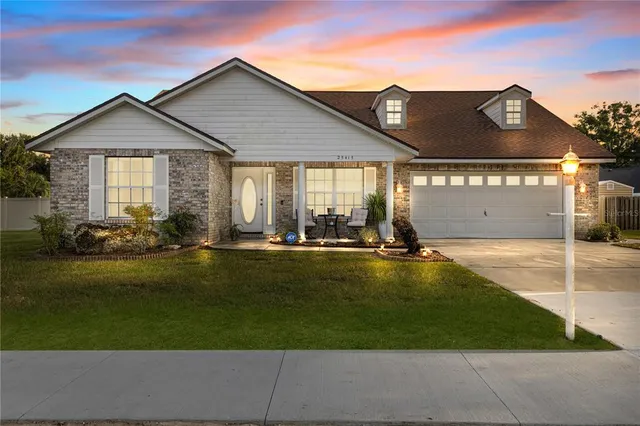 a front view of house with yard and outdoor seating