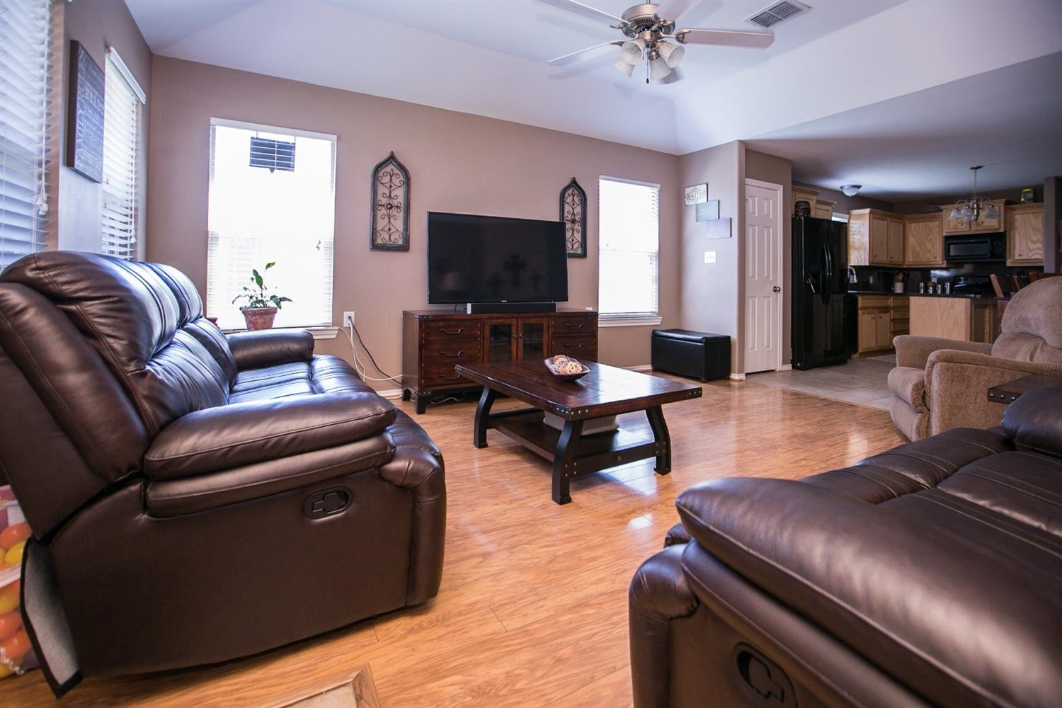 2204 100th Street Lubbock, TX 79423 - Photo 4 of 10 a living room with furniture and a flat screen tv