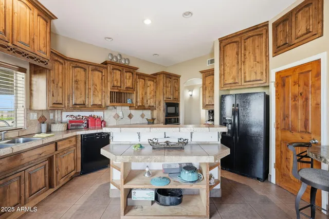 a kitchen with stainless steel appliances granite countertop a stove and cabinets