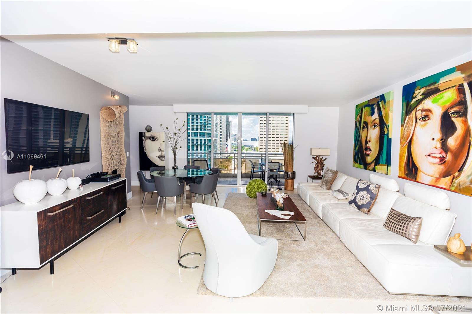 901 Brickell Key Boulevard, Unit 1406 Miami, FL 33131 - Photo 2 of 25 a living room with fireplace furniture and a flat screen tv