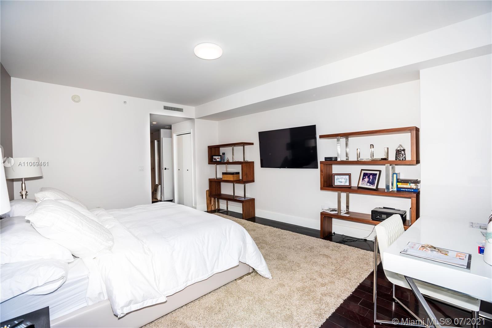 901 Brickell Key Boulevard, Unit 1406 Miami, FL 33131 - Photo 12 of 25 a bedroom with a bed and a flat screen tv