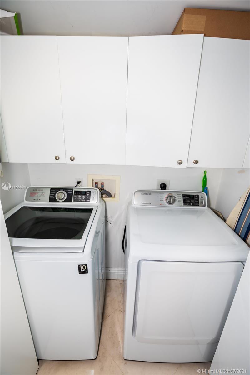 901 Brickell Key Boulevard, Unit 1406 Miami, FL 33131 - Photo 14 of 25 a utility room with dryer and washer