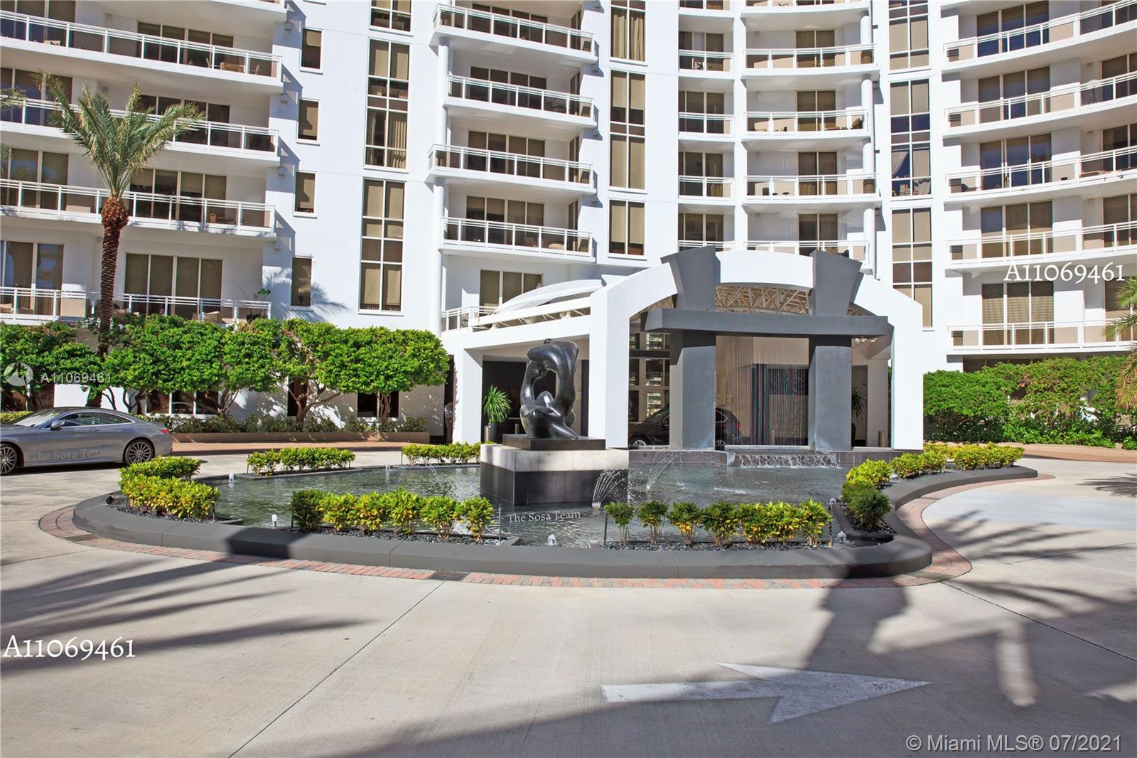 901 Brickell Key Boulevard, Unit 1406 Miami, FL 33131 - Photo 20 of 25 front view of a building and a garden