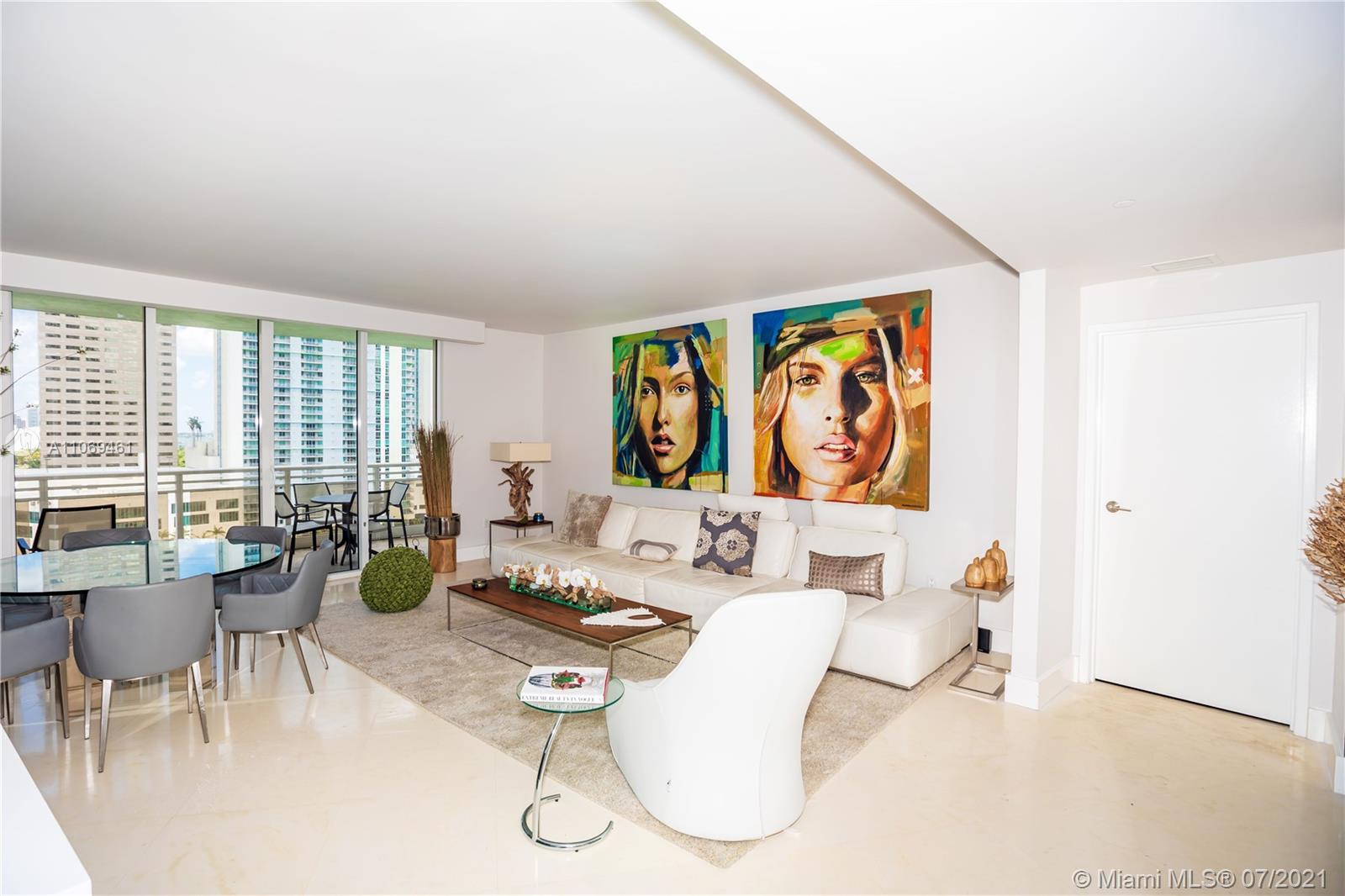 901 Brickell Key Boulevard, Unit 1406 Miami, FL 33131 - Photo 3 of 25 a living room with furniture large window and dining table