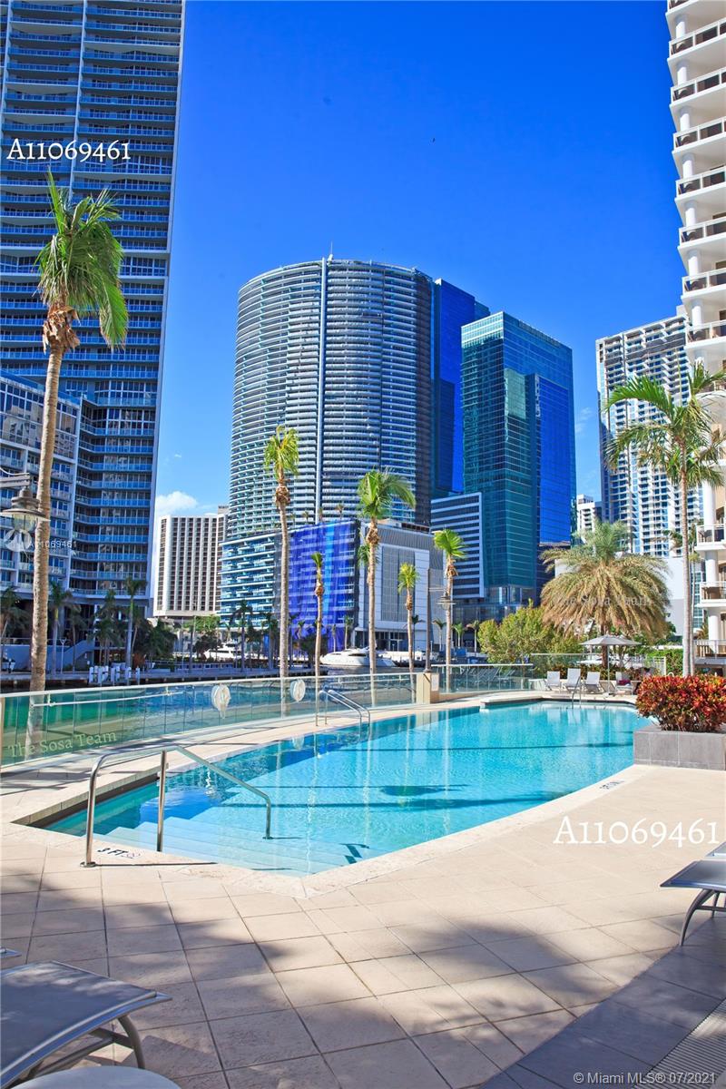 901 Brickell Key Boulevard, Unit 1406 Miami, FL 33131 - Photo 21 of 25 a view of a brick building next to a yard