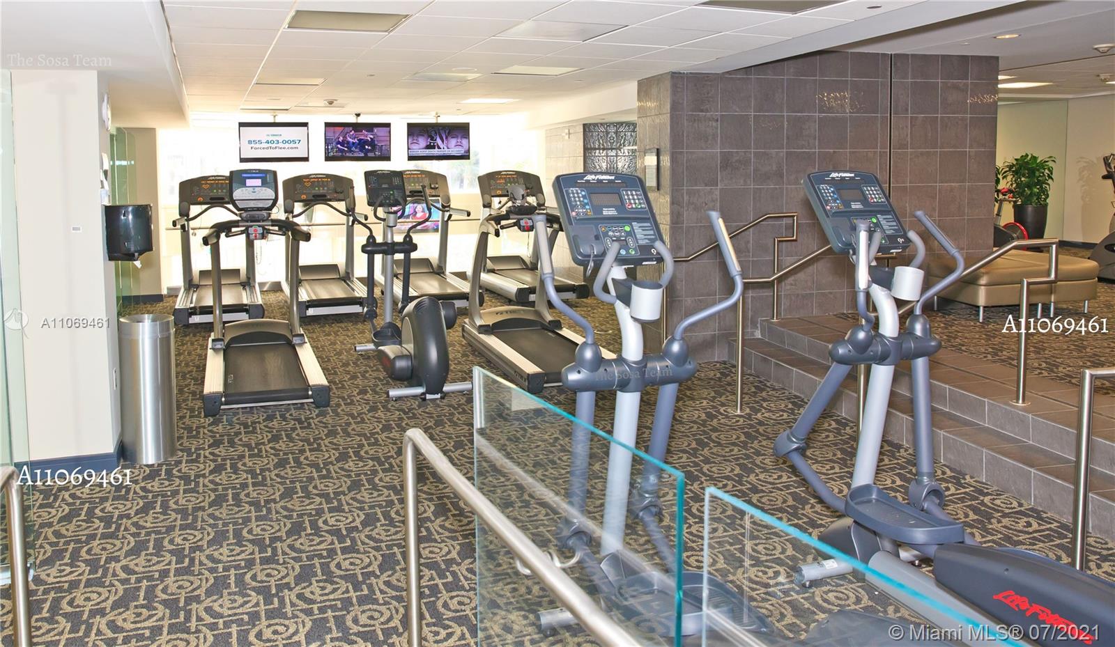 901 Brickell Key Boulevard, Unit 1406 Miami, FL 33131 - Photo 23 of 25 a view of a room with gym equipment