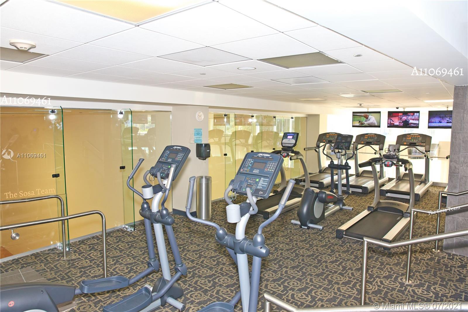 901 Brickell Key Boulevard, Unit 1406 Miami, FL 33131 - Photo 24 of 25 a view of a room with gym equipment