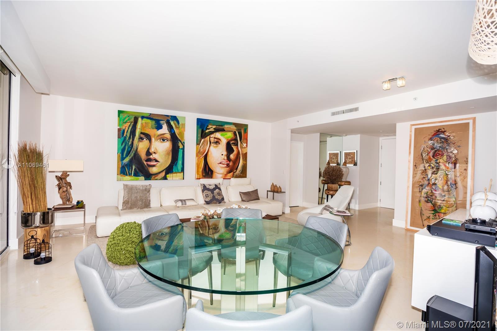 901 Brickell Key Boulevard, Unit 1406 Miami, FL 33131 - Photo 6 of 25 a dining room with furniture a rug and a painting