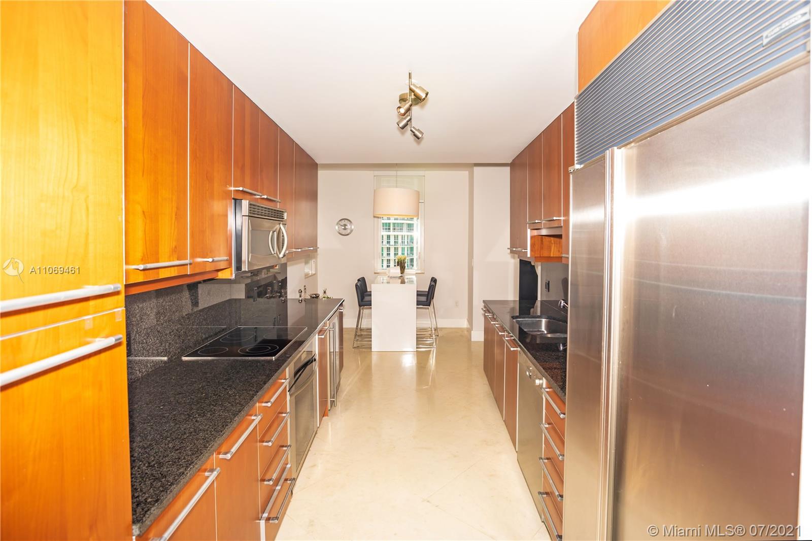 901 Brickell Key Boulevard, Unit 1406 Miami, FL 33131 - Photo 9 of 25 a view of a kitchen with a sink and cabinets