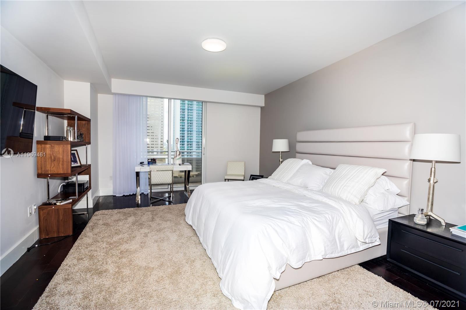 901 Brickell Key Boulevard, Unit 1406 Miami, FL 33131 - Photo 10 of 25 a bedroom with a bed and furniture