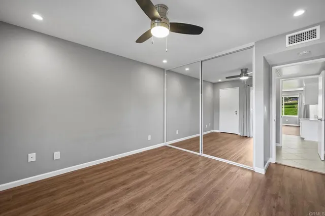a bathroom with a granite countertop sink a toilet and shower