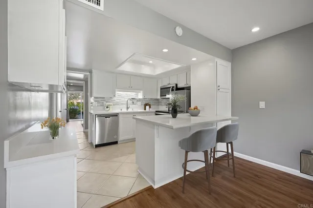 a kitchen with stainless steel appliances a refrigerator sink and cabinets