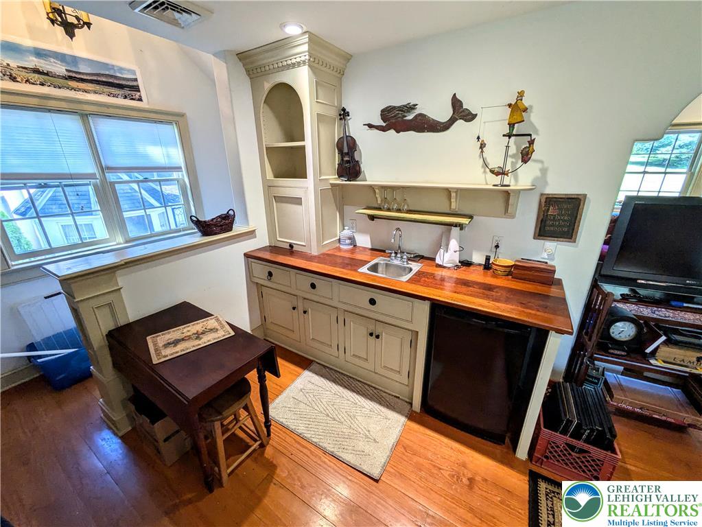 1731 Howell Road Easton, PA 18040 - Photo 34 of 60 Gleaming hardwood floors and a built-in wet bar with warm wood counters anchor this functional space.
