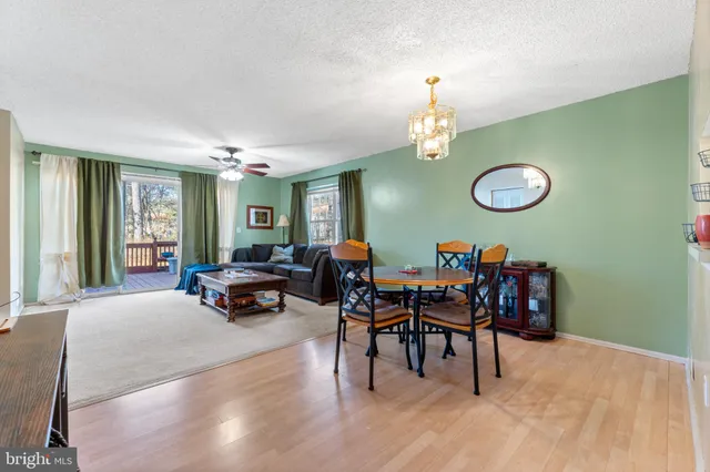 a living room with furniture dining table and a large window