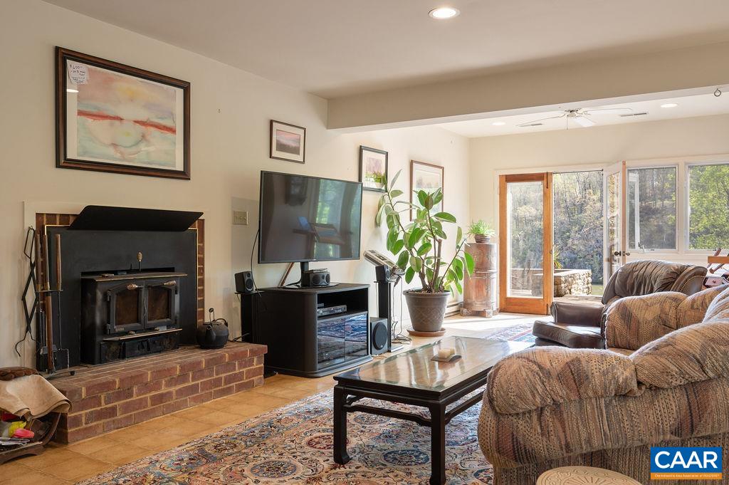 340 Cedar Bluff Road Charlottesville, VA 22901 - Photo 40 of 75 a living room with furniture a large window and a flat screen tv